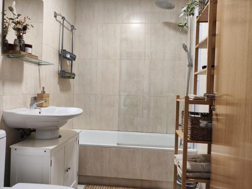 a bathroom with a sink and a toilet and a bath tub at Apartamento tranquilo en miengo in Miengo