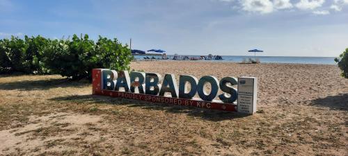 a sign for a barbados restaurant on a beach at Breezy Vista on the Terrace - West Coast, Saint James, Barbados in Saint James