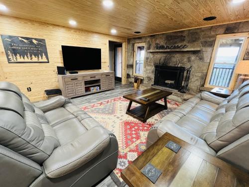 a living room with couches and a tv and a fireplace at Dolly's # 2 condo in Sevierville
