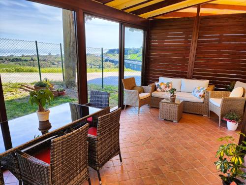 a screened in porch with chairs and a couch at La Casa di Vandina in Senigallia