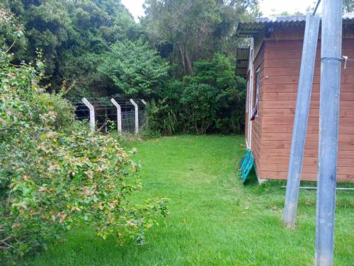 a yard with a fence and a building at Inature in Florianópolis