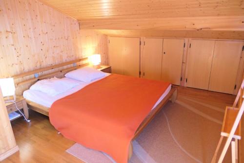 a bedroom with a large bed in a wooden room at Chalet Granier - Chalets pour 6 Personnes 34 in Saint-Gervais-les-Bains