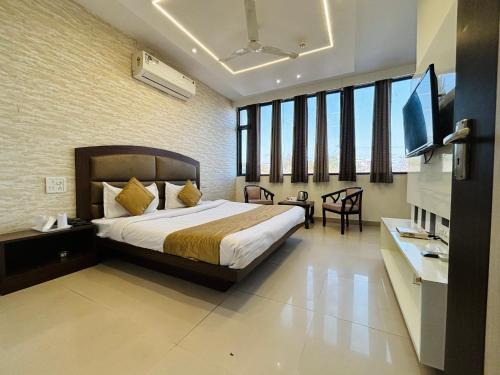 1 dormitorio con 1 cama y TV en Hotel The Benz, en Chandīgarh