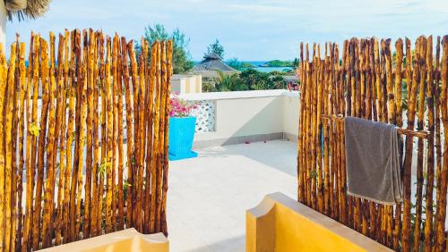 a fence made of wooden sticks with a towel at Casa Maridadi in Watamu