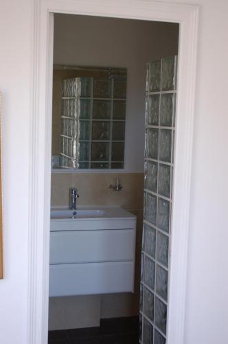 a bathroom with a tub and a window and a sink at Villa Sotavent in Vall-Llobrega