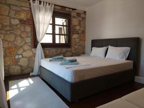 a bedroom with a bed with towels on it at ANASTASIA STONE HOUSE in Psakoudia