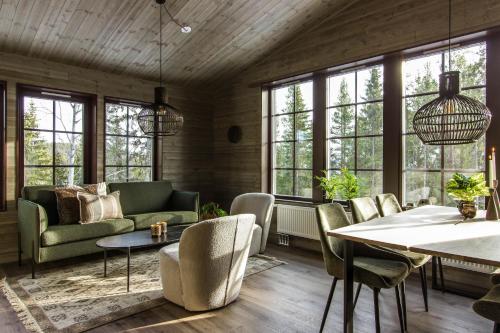 a living room with a couch and a table at Parkstigens Fjällby - Kåvan in Funäsdalen