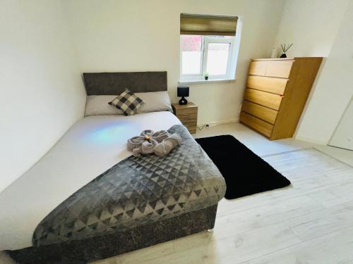 a bedroom with a large bed and a dresser at The Studio Serviced Apartment By AltoLuxoExperience Short Lets & Serviced Accommodation With Free Wifi in Bristol