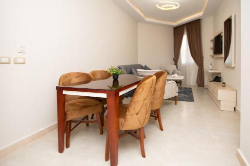 a dining room table and chairs in a living room at Marom Port Said Resort & Beach in Port Said