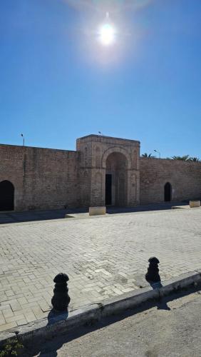 a large brick building with an arch in the middle at Cœur de Mahdia in Mahdia
