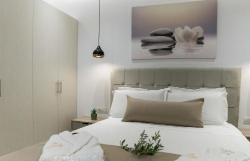 a bedroom with a white bed with white pillows at Anthelia Luxury Villas in Karpathos Town