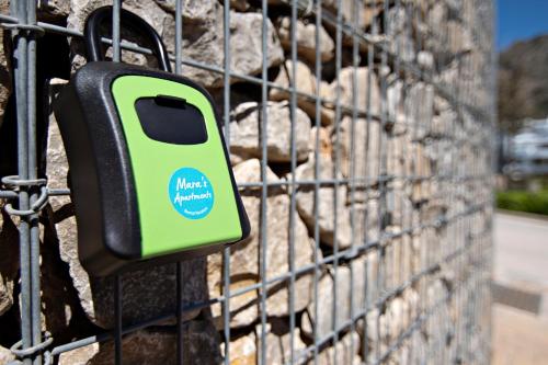 a green object is attached to a fence at Mara's Apartments Higuerón West - Luxurious & Sunny in Fuengirola