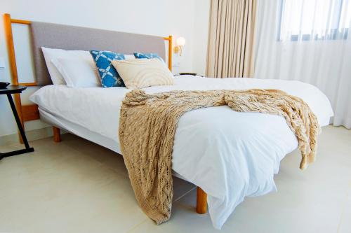a bedroom with a bed with a blanket on it at Mara's Apartments Higuerón West - Luxurious & Sunny in Fuengirola