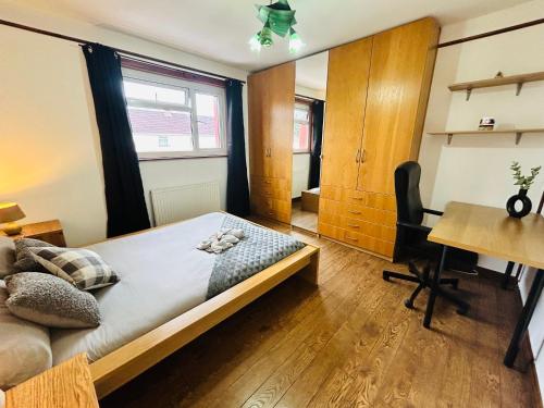 a bedroom with a bed and a desk and a table at The Portuguese 3 Bedroom House & Studio By AltoLuxoExperience Short Lets & Serviced Accommodation With Free Parking in Bristol