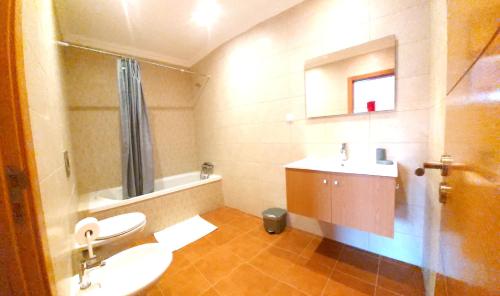 a bathroom with a sink and a toilet and a tub at Ocean & Nature Flat - Aljezur - Algarve West Coast - 1,6km Praia Monte Clérigo in Aljezur