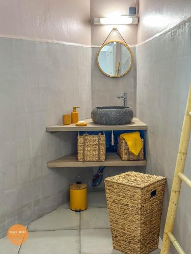 a bathroom with a sink and a mirror at Villa Doucè Soley in Rivière-Pilote