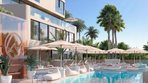 a hotel with a pool with white chairs and umbrellas at Mara's Apartments Higuerón West - Luxurious & Sunny in Fuengirola