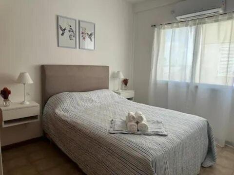 a bedroom with a bed with a teddy bear on it at La Plaza Lobos Apartment in Lobos