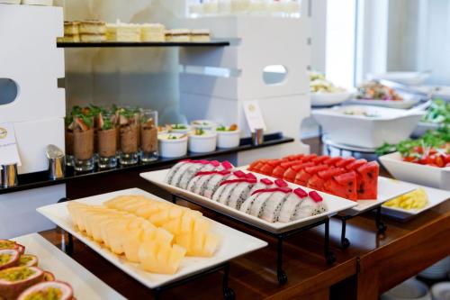 a buffet with different types of food on display at Champton Hanoi Hotel in Hanoi