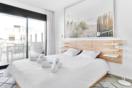 a bedroom with two beds and a large window at Playa Carabassi Sea View Apartment in Gran Alacant, Large Terrace in Gran Alacant