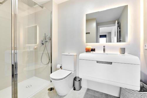 a bathroom with a toilet and a sink and a shower at Playa Carabassi Sea View Apartment in Gran Alacant, Large Terrace in Gran Alacant