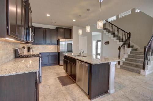 a kitchen with a counter top and a staircase at Roseberg-Suglarland 3-BR - Extended Stay 30 days in Rosenberg