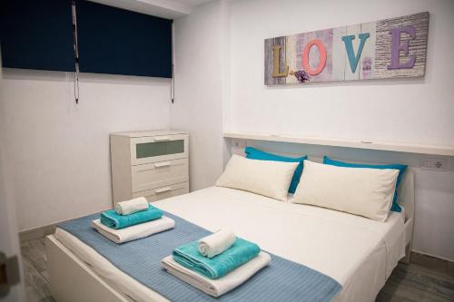 a bedroom with a bed with towels on it at DANICO PLAYA HONDA 218 in Playa de las Americas