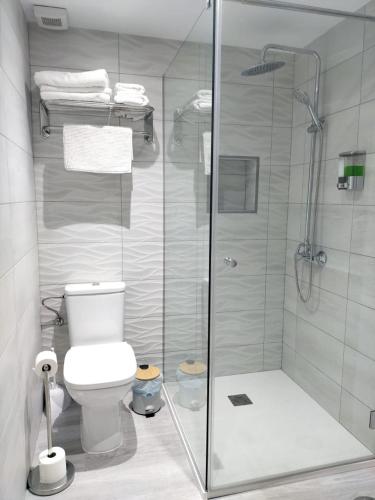 a bathroom with a toilet and a glass shower at Enjoy Morro Jable in Morro del Jable