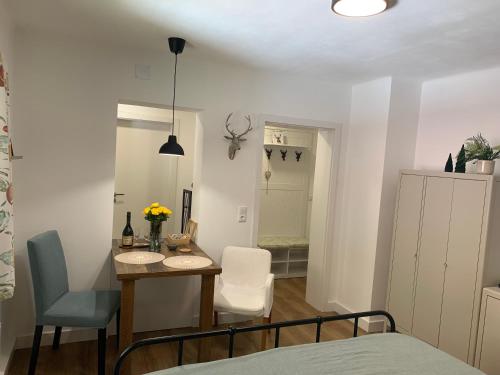 a room with a table and chairs and a bedroom at Iris Apartments in Obertraun