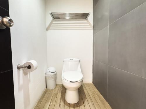 a bathroom with a white toilet in a stall at Eco Bay Hotel in Bahía Kino