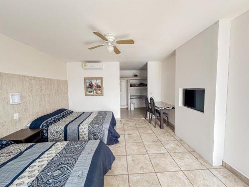 a hotel room with two beds and a ceiling fan at Eco Bay Hotel in Bahía Kino