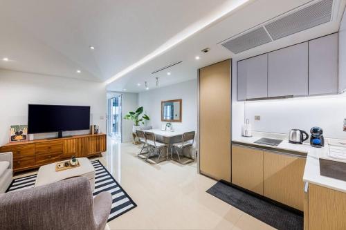 a kitchen and a living room with a table at Iconic skyline, Big apartment, Great location in Bangkok