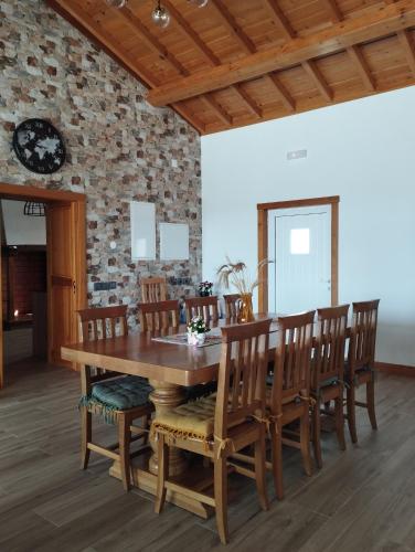 a dining room with a wooden table and chairs at Quinta da Fonte in Torneira