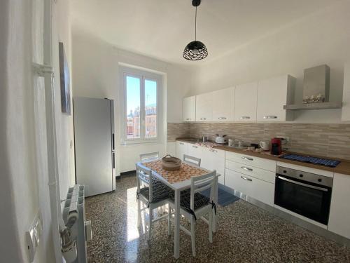 a kitchen with a table with chairs and a sink at Brignole Home in Genova