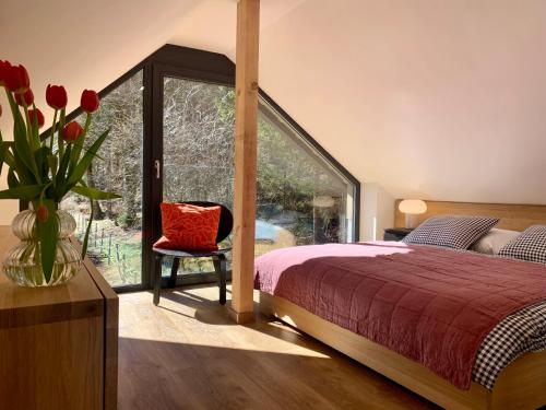 a bedroom with a bed and a vase of flowers at Iris Apartments in Obertraun