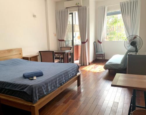 a bedroom with a bed and a living room at Riverhome Saigon Apartments in Ho Chi Minh City