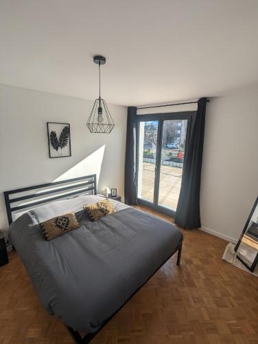 une chambre avec un lit et une grande fenêtre dans l'établissement Cosy et moderne avec Clim - Dent d'Oche, à Thonon-les-Bains