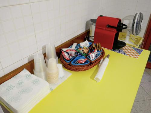 a yellow counter with a basket of dishes on it at Le Magnolie Paliano appartamento 120 mq in Paliano