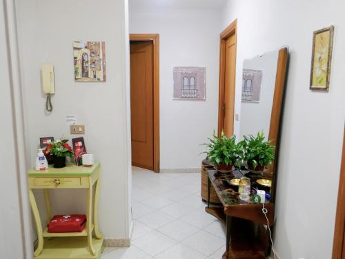 a hallway with a door and a table with plants at Le Magnolie Paliano appartamento 120 mq in Paliano