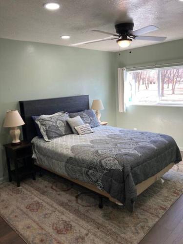 a bedroom with a bed and a ceiling fan at Helper Sunrise Peak in Helper