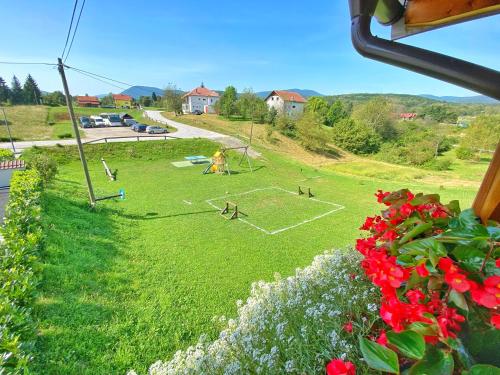a view of a soccer field in a field with flowers at 16 Lakes Hotel in Grabovac