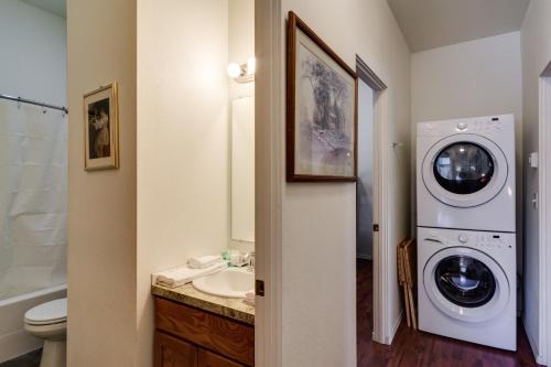 a bathroom with a washing machine and a washer at Maple Leaf Manor Suites in Spokane