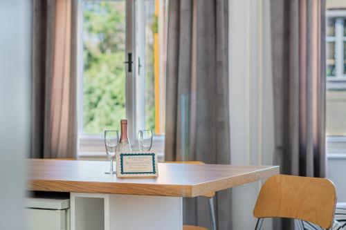 a table with two wine glasses on top of it at Apartmány Rozárka Turnov in Turnov