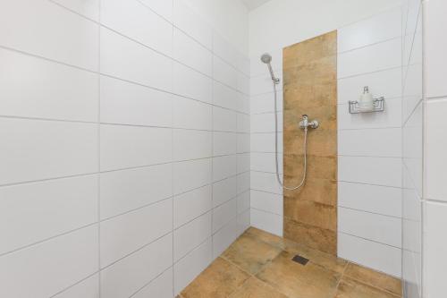 a bathroom with a shower with white tiled walls at Apartmány Rozárka Turnov in Turnov