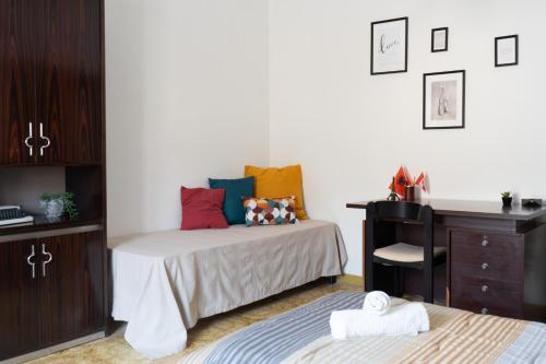 a bedroom with two beds and a dresser and a bed at Casa di Nonna Linda in Portocannone