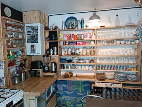 une cuisine avec beaucoup d'étagères dans l'établissement Vila beauvoir, à Saint-Pol-de-Léon