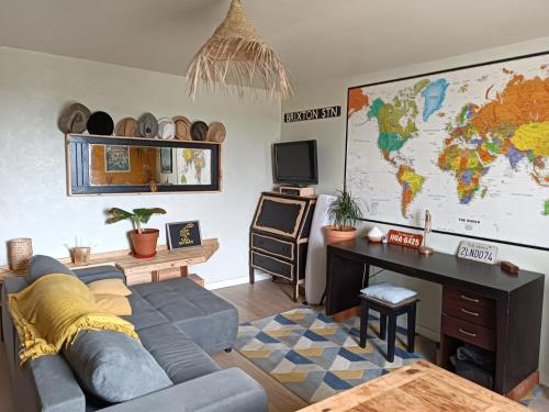 un salon avec un canapé, un bureau et une carte dans l'établissement Vila beauvoir, à Saint-Pol-de-Léon