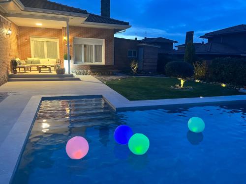 a backyard with a pool with colorful balls in it at Gorriones in Pelayos de la Presa