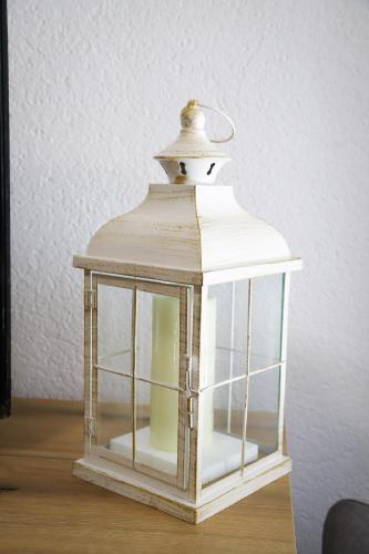 a small white lantern sitting on top of a table at Kuća JEKA in Vrnjačka Banja