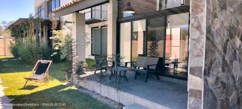 a patio with a table and a chair next to a building at Loft Rosado in Tequisquiapan